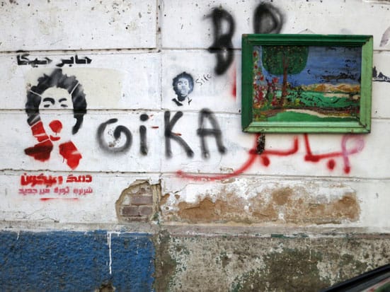 Ronnie Close, Stencil for April 6th murdered member, Giko, 17 years old, Tahrir Sq Nov 2012. (don't know what the painting is doing there)