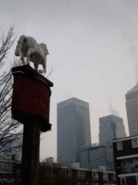 Old pub sign, council flats and Canary Wharf, phototgraph Richard Whitby