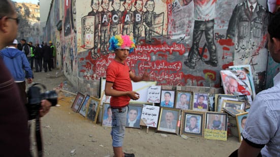 Ronnie Close, Street protest against President Morsi, Tahrir Sq Nov 2012. (wigs and masks are popular).